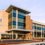 Collaborative Health Center Exterior. A large four story building with large windows.