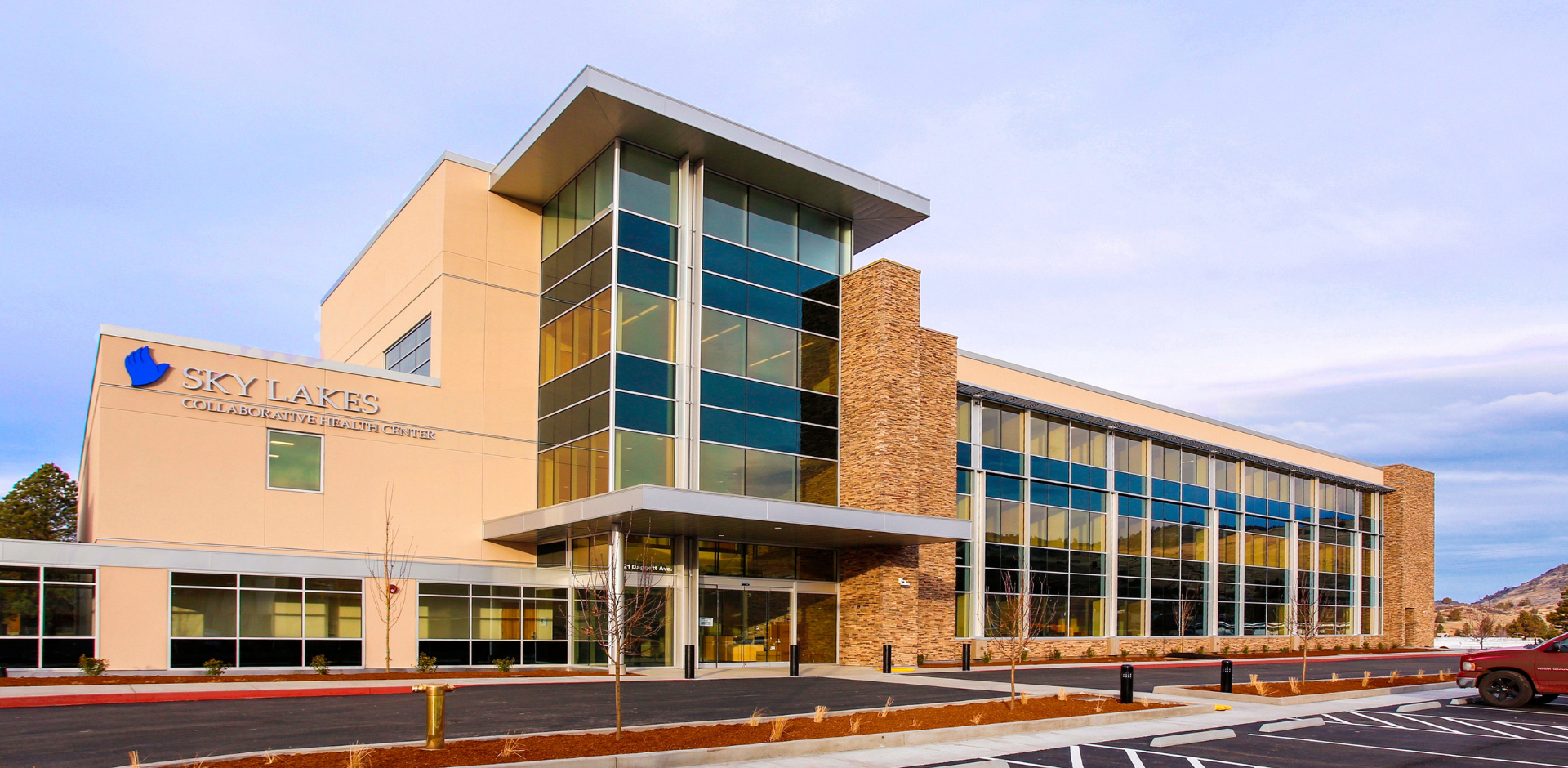 Collaborative Health Center Exterior. A large four story building with large windows.