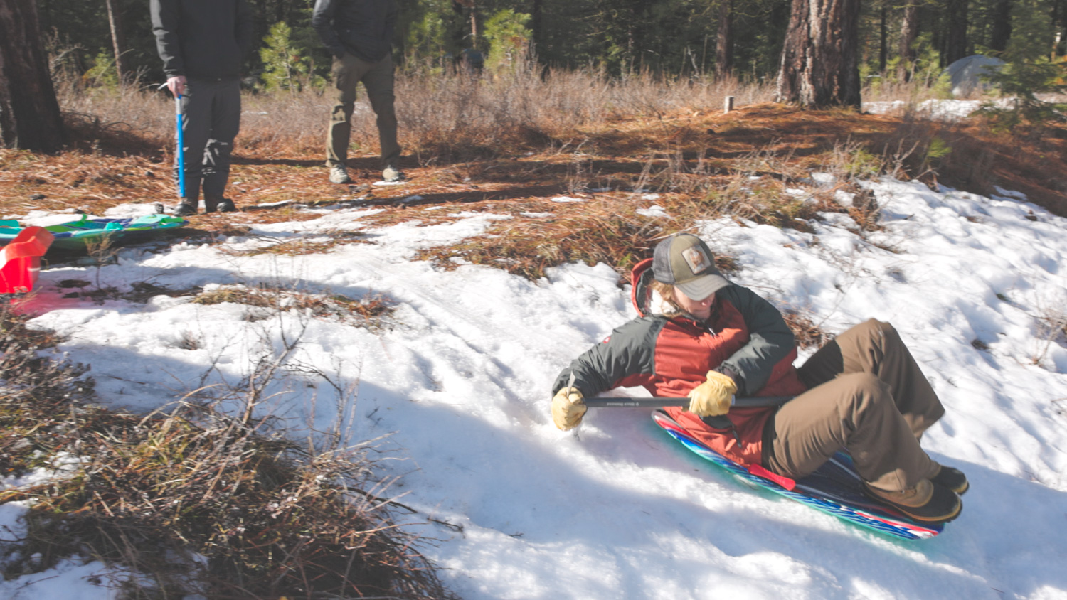 Participant simulating a fall and using an ice axe to stop the fall