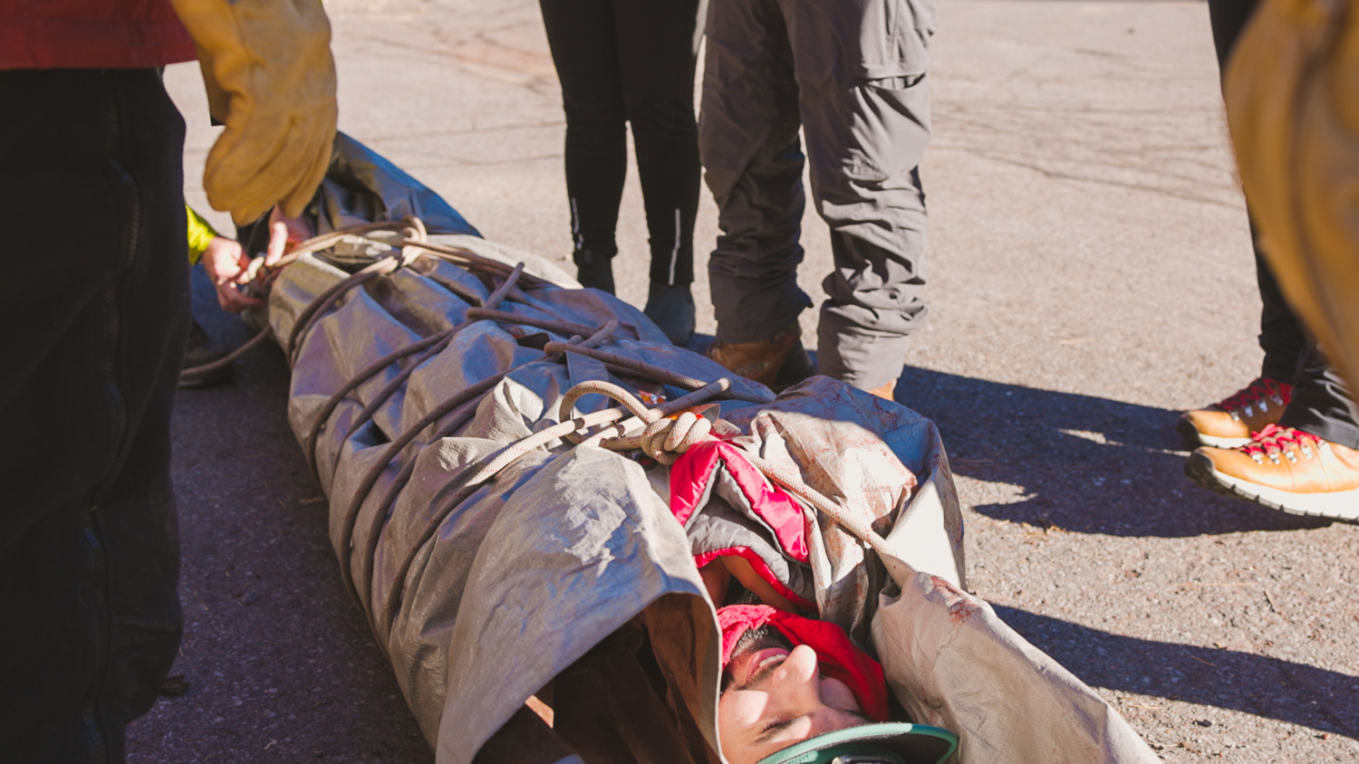 Participant wrapped in tarps for a rescue