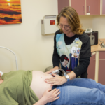 Bobi Staffler preps pregnant patient for an ultrasound.