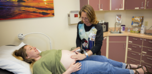 Bobi Staffler preps pregnant patient for an ultrasound.